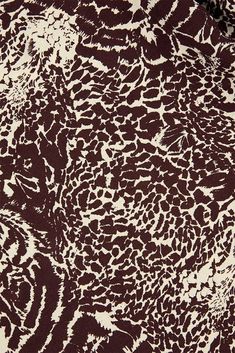 an animal print fabric is shown in brown and white