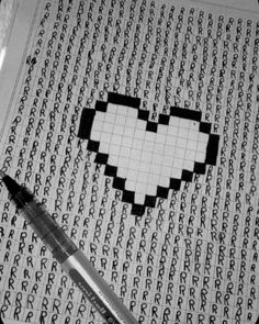 a heart made out of letters on a sheet of paper with a pen next to it