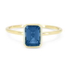 An emerald cut London blue topaz (1.25ct) is the striking focal point of this commanding fashion ring. The December birthstone is set in a 14k yellow gold bezel. Bezel Set Ring, Fashion Ring, December Birthstone, London Blue Topaz, Blue Topaz Ring, London Blue, Topaz Ring, Bezel Setting