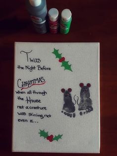 two mice on a white towel with christmas decorations around them and three bottles of toothpaste next to it