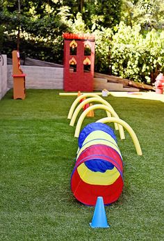 an inflatable ball is laying on the grass next to a bouncy ring