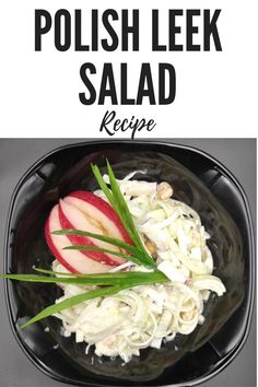 a black bowl filled with coleslaw and sliced apples on top of a table