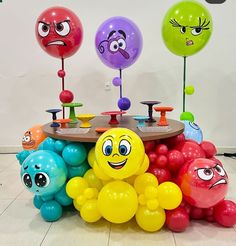 there are many balloons with faces on them