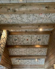 the inside of a restaurant with wood paneling and decorative wall paper on the ceiling