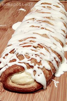 a loaf of bread covered in icing on a cutting board