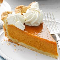 a slice of pumpkin pie with whipped cream on top