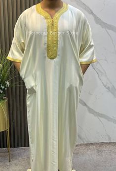 BEIGE kaftan for men With gold This is a perfect Wedding outfit for men, wedding kaftan for men, Moroccan kaftan for men  Approximate measurements Size XL : length: 142 cm // 55.90"         shortening is free chest width: 66 cm // 25.98" Size XXL : length: 144 cm // 56.69"         shortening is free chest width: 70 cm // 27.55" Kaftan CARE: Hand wash cold, air dry With a practical pocket on the right side and an opening on the other side for easy access to the pants underneath, this magnetic men Ceremonial Gold Thobe For Eid, Gold Thobe With Dabka For Traditional Ceremonies, Gold Long Thobe With Dabka, Ceremonial White Kaftan With Dabka, Ceremonial White Dabka Kaftan, Gold Thobe For Eid And Traditional Ceremonies, Ceremonial Dabka Thobe For Eid, Long Ceremonial Thobe With Dabka, Wedding Outfit For Men