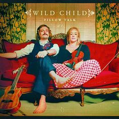 an mp3 player with the words wild child and two women sitting on a red couch