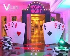 the las vegas night casino is lit up with neon lights and playing cards on the floor