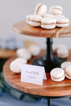 two tiered trays with macaroons on top of each other and a card