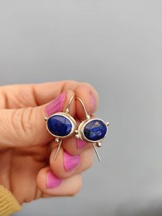 These are very pretty Handmade Earrings. They are made from Recycled Sterling Silver and oval Lapis Lazuli cabochons, and they are light and comfortable. Approximately 23mm long by 16mm wide. The cabochons themselves measure 12 mm X 10 mm each. Lapis Lazuli is a birthstone for September. The earrings will be a perfect present. Everything I sell is handmade by myself in my Wiltshire studio. Thank you for supporting handmade. Vintage Gold Earrings, Stamped Earrings, Cabochon Earrings, Lapis Earrings, Present For Her, Lapis Lazuli Earrings, Handmade Sterling Silver Rings, Romantic Jewellery, Evil Eye Earrings