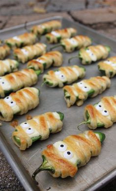 some food is on a pan and ready to be cooked in the oven with eyes drawn on them