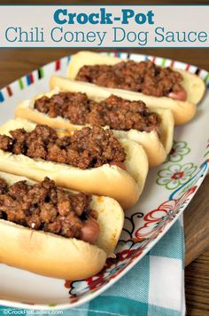 three chili cheese dogs on a plate with the words crock - pot chili coney dog sauce