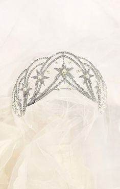 "Celestial stars and Hollywood glamor make the MARCIA tiara unique and beautiful.  The Art-nouveau lines of this large tiara are paved with Austrian crystals and studded with simulated pearls.  There is a little \"give\" in the metal to help adjust it to your head. This is an exciting tiara for any special event with a celestial theme-- especially if you're the star of the show! UNBOXING Your beautiful hair adornments will arrive in an heirloom velvet jewelry box, specially designed for our Crowned by Juliet tiaras and headpieces. Prepare for princess packaging! MEASUREMENTS High point: 2.75 inches, Length: 13\", Embellished length: 10\", Diameter: 6\". Weight: 5.5 oz. High point: 7 cm, Length: 33 cm, Embellished length: 25 cm, Diameter: 15 cm  Weight: 155 grams  SHIPPING in USA Tracked sh Princess Packaging, Celestial Tiara, Star Tiara, Hollywood Glamor, Crystal Headpiece Wedding, Celestial Theme, Celestial Stars, Pageant Crowns, Queen Princess