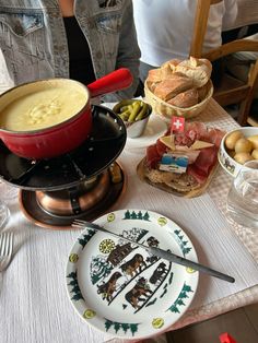 a table topped with plates and bowls filled with food next to other dishes on top of a white table cloth