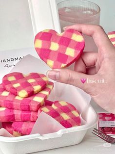 pink and yellow heart shaped cookies in a container