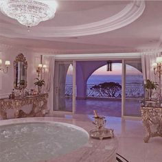 a fancy bathroom with a jacuzzi tub and chandelier