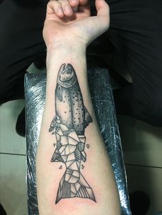 a man's arm with a tattoo on it that has an image of a rocket ship