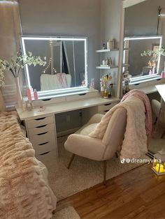 a bedroom with a bed, desk and mirror