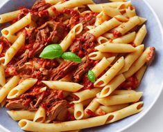 pasta with meat and sauce in a blue bowl