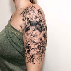 a woman with a cat tattoo on her arm