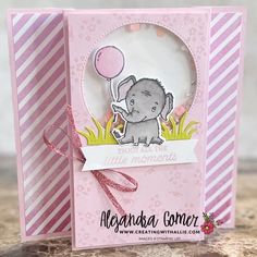 a pink card with an elephant holding a balloon