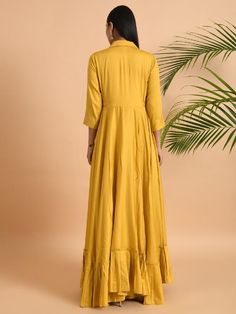 A shawl collared cotton silk maxi dress with flared and flounced bottom, side pockets, and long sleeves Garment measurements (in Inches): Small: Bust - 39", Waist - 29" Medium: Bust - 42", Waist - 32" Large: Bust - 45", Waist - 35" Length: 55-56", Sleeve length: 17" Fabric: Cotton Silk Color: Yellow Fit: Model height is 5'7" Model is wearing a size S Loose and comfortable fit. Instructions: Hand wash separately in cold water Note: Available in other colors Pants not included with the product Pan Rayon Long Sleeve Maxi Dress For Fall, Rayon A-line Maxi Dress, Fitted Cotton Floor-length Kurta, Fitted Floor-length Cotton Kurta, Fitted Long Maxi Dress With Ruffles, Flowy Festive Maxi Dress, Fitted Floor-length Kurta For Spring, Fall Rayon Maxi Dress, Flowy Long Sleeve Cotton Maxi Dress