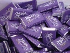 a pile of purple candy bars sitting on top of each other