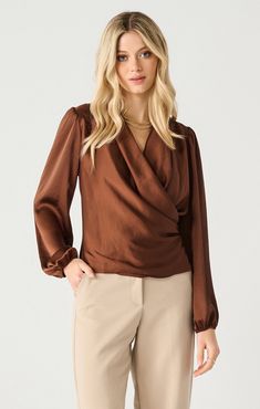 Turn up the heat with our Warm Ember Blouse! This elegant cognac satin blouse features a stylish surplice front that's perfect for the upcoming Thanksgiving festivities. Pair with your favorite denim for a chic and effortless look. Don't miss out on this must-have piece! Cognac, satin Surplice front Straight fit Puff sleeves The material is 100% Polyester. The blouse runs a little small, we recommend sizing up. The model is 5'9" and is wearing a size small. Care instructions: Hand wash cold, han Shady Lady, Silky Top, Black Tape, Elegant Blouses, Wrap Blouse, Cropped Style, Fall Wardrobe, Polished Look, Wrap Style