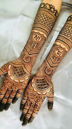 two hands with henna designs on them