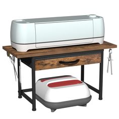 a printer sitting on top of a wooden table next to a white and red object