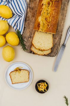 sliced loaf of lemon bread on a cutting board next to some lemons and other food