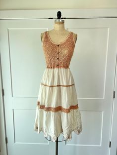 "Vintage paneled bohemian crochet summer dress with embroidered floral trim hem and adjustable waist. This is a super cute dress for a summer lunch or dinner and is in excellent vintage condition B: 33\" W: 24\" to 28\" L: 47\"" Summer Festival Crochet Dress With Lace Trim, Bohemian Midi-length Crochet Dress For Summer, Bohemian Crochet Dress For Garden Party, Summer Lace Dress With Embroidered Hem, Bohemian Crochet Midi Dress For Summer, Summer Lace Dresses With Embroidered Hem, Cotton Lace Patchwork Dress For Vacation, Fitted Crochet Sundress With Lace Trim, Beige Boho Dress With Lace Trim For The Beach