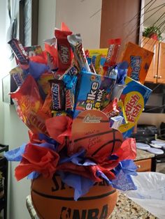 a basket filled with candy and candies in the shape of a basketball sitting on top of a counter