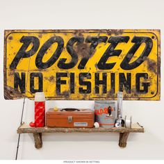 there is a sign that says posted no fishing on the wall next to some other items