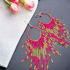 Beautiful, bead earrings in  pink and gold colour   Length 14 cm, width 4 cm.   Handmade earrings . Very light weight you can wear with any type of outfit . ocassionaly or regulary Very beautiful geometric shape earring Colorful Beads Dangle Chandelier Earrings, Colorful Beaded Dangle Chandelier Earrings, Dangle Chandelier Earrings With Colorful Beads, Bohemian Pink Hoop Earrings As A Gift, Bohemian Pink Hoop Earrings Gift, Handmade Pink Beaded Earrings With Round Beads, Handmade Pink Beaded Earrings, Pink Beaded Earrings With Round Beads For Pierced Ears, Bohemian Pink Hoop Earrings With Round Beads