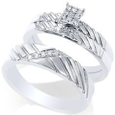 two white gold wedding rings with diamonds on each one and an arrow design in the middle