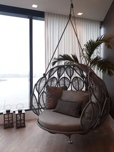 a swing chair hanging from the ceiling in a living room