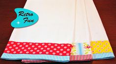 a white table cloth with polka dots on it and a blue tag that says retro fau