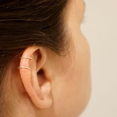 A unique ear cuff that clips onto the ear without the need for piercings. A great earring for those who do not have the piercing but want the look! + Material - Stainless Steel, Titanium, Sterling Silver, Yellow Gold Fill, Rose Gold Fill, 14k Gold + Ring Size - 8mm Diameter + Cuff Length - 9mm long + Price is for one Ear cuff! + Packaged in Brown Kraft box NOTE This Earring does not require a pierced ear! The model is wearing the sterling silver option and that is the option shown in the picture Minimalist Adjustable Pierced Ear Cuff, Minimalist Pierced Adjustable Ear Cuff, Minimalist Huggie Ear Cuff With Ear Wire, Minimalist Everyday Internally Threaded Ear Cuff, Adjustable Minimalist Hoop Ear Cuff, Adjustable Nickel Free Minimalist Wrap Earrings, Minimalist Adjustable Nickel-free Wrap Earrings, Adjustable Hypoallergenic Minimalist Ear Cuff, Minimalist Hypoallergenic Huggie Ear Cuff