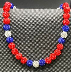 Adjustable Bling Beaded Necklace For Gift, Adjustable Rhinestone Necklaces With Round Beads, Adjustable Rhinestone Necklace With Round Beads, Blue And Red Beaded Necklace, Cheap Patriotic Beaded Necklaces, Patriotic Red Beaded Necklaces, Adjustable Patriotic Red Necklace, Red White And Blue Necklace, Baseball Necklace