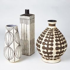 three ceramic vases sitting next to each other