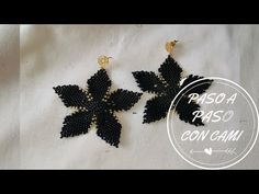 two black beaded leaves are shown on a white background with the words paso paso con camu below it