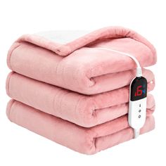 three blankets stacked on top of each other with thermometer attached to one blanket