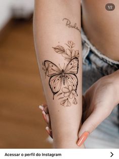 a woman with a butterfly tattoo on her arm