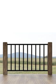 an empty balcony with wooden flooring and black iron railings in the foreground