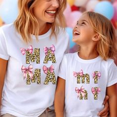 Cute Custom Mommy and Me Shirts Make Great Gifts! These colorful and fun t-shirts will be a big hit for moms and kiddos! ABOUT YOUR T-SHIRT: (adult, youth, toddler) BELLA & CANVAS 3001 JERSEY SHORT SLEEVE TEE *Regular fit for casual wear *Side seamed shirt with tearaway label *Rib knit collar with seam *Shoulder tape to prevent stretching *100% cotton except for the following colors: -Ash: 99% cotton, 1% polyester -Athletic & black heather: 99% cotton, 1% polyester -Other heather colors: 52% cot Cute Summer T-shirt For Parenting, Fun Letter Print Tops For Family Occasions, Cute Family Shirt With Name Print, Cute Family Shirt With Letter Print, Playful Funny Print Family T-shirt, Cute Family Tops With Funny Print, Pink Matching Tops For Mother's Day, Cute White Shirt For Family Events, Playful Pink Tops For Mother's Day