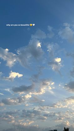 the sky is filled with white clouds and blue skies, as well as an airplane in the distance