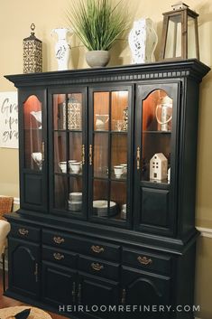 a black china cabinet with glass doors