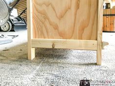 a wooden cabinet sitting on top of a carpeted floor